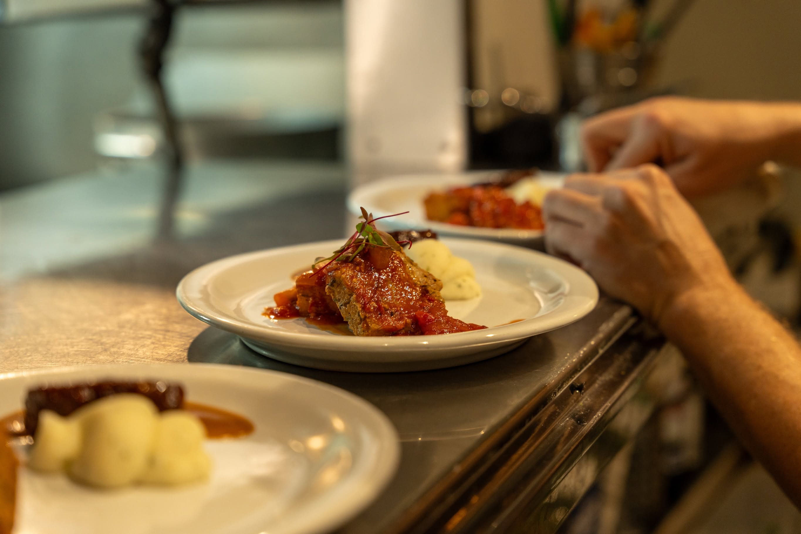 A dish being finished in the Baker and Wife kitchen